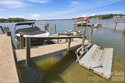 The dock is equipped for an active waterfront lifestyle, with dedicated space for a boat and personal watercraft. Easy access to open water makes it simple to launch a day of cruising, watersports, or relaxing on the lake.