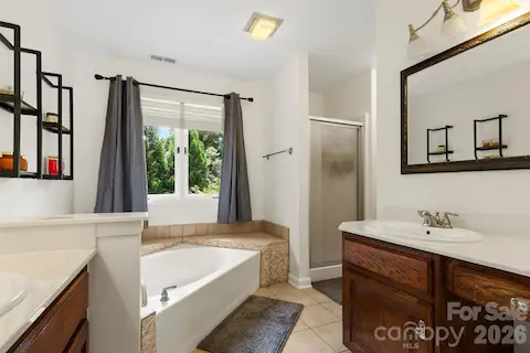 Primary bathroom with 2 sinks, oversized tub & separate shower