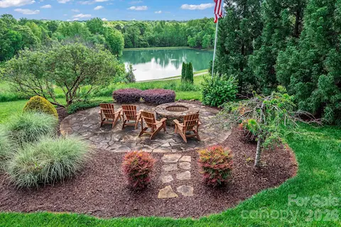 Outdoor fireplace overlooking the neighboring pond.