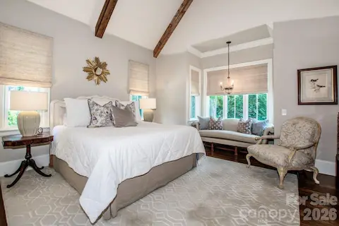 Primary BR with a vaulted ceiling with beams and a bay window