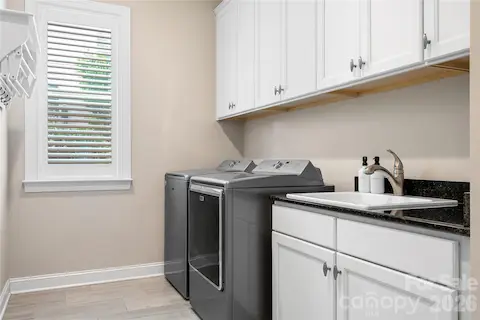 Laundry Room Has Plenty Of Cabinets And Utility Sink- Washer And Dry Will Convey