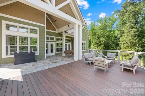 Stone and trex decking, swing, and outdoor speakers