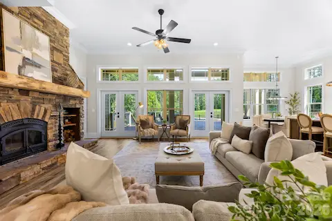 Wood burning fireplace with blower, set of doors leading to back patio/pool area