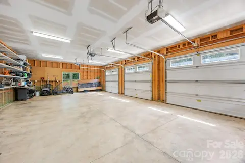 Three car garage with storage racks, additional storage not shown in picture