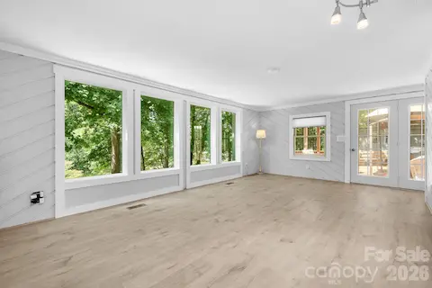 Living Room is flooded with natural light, the new full length windows add extraordinary water views