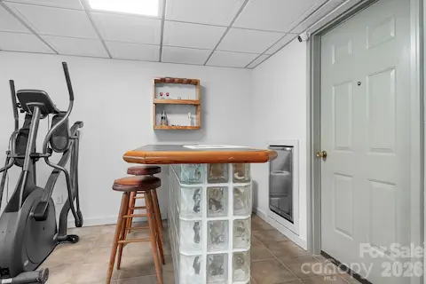 Bar in basement with a mini fridge