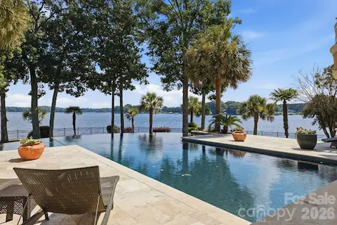 Exceptional outdoor living surrounds the waterfront pool with expansive spaces for lounging and entertaining.