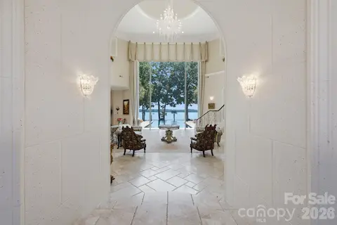 Elegant foyer opens to soaring ceilings and beautiful sightlines toward the lake.