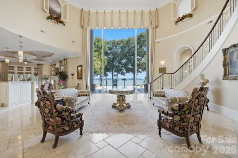 Dramatic two-story great room filled with natural light and expansive waterfront views.
