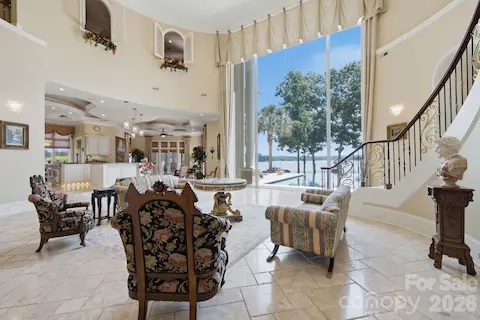 Floor-to-ceiling windows showcase Lake Norman while flooding the great room with natural light.