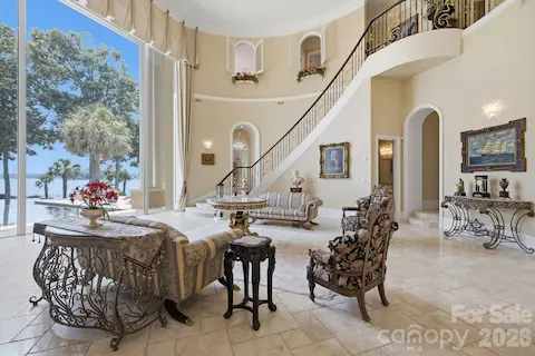 Sweeping staircase, soaring ceilings and detailed architectural finishes define the impressive main living area.
