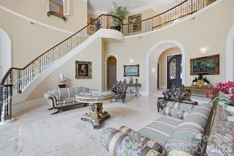 Impressive two-story great room features a dramatic wall of windows, elegant architectural details and sweeping Lake Norman views.
