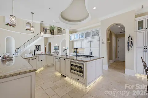 Spacious kitchen offers abundant cabinetry, generous counter space and an open connection to the living areas.