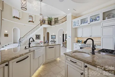 Large center island anchors the kitchen with plenty of workspace, storage and seating.