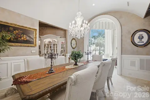 Elegant formal dining room features a distinctive curved ceiling, refined architectural details and a sophisticated setting for entertaining.