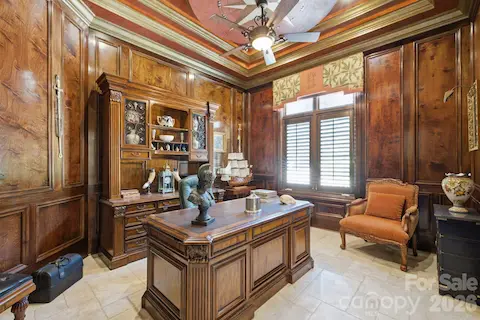 Rich wood-paneled private office creates a distinguished work from home setting.