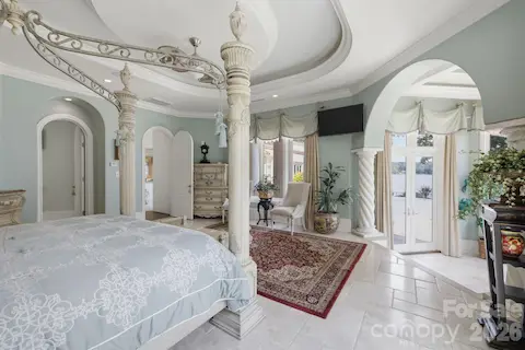 Generously sized primary bedroom with large windows and a bright, inviting feel.