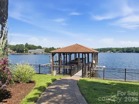 Private covered dock features two cable boat lifts and two PWC lifts, providing plenty of space for enjoying life on Lake Norman.