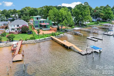 Aerial view of the back of the home with a dock and pier.
