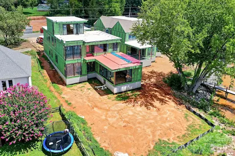 Real life construction process showing the home is under roof with windows and roofing completed in 8/2026. Has a fantastic backyard for a pool!