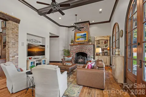 Grand floor to ceiling brick fireplace that has been converted to operate with gas.