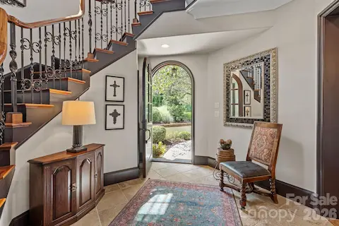 Elegant and welcoming entry with a curved foyer staircase.