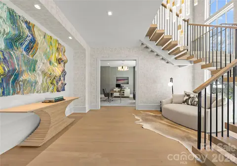 Entry foyer. The area under the floating staircase makes a great reading nook or the perfect place for a grand piano!