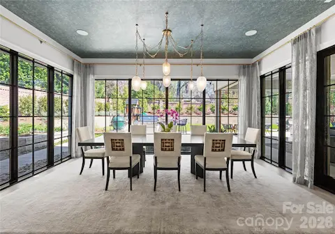 Designer lighting, wallpaper and window treatments adorn the stunning dining area.