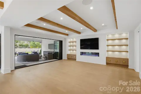 View of accordion window wall open to covered patio. Wonderful flow from indoors to out.