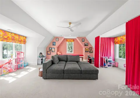 Bonus room with motorized shades, reading bench with custom velvet cushion, and adorable  "theater" curtains.
