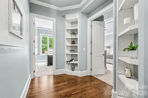 Built-ins lead you to the Primary Bedroom w/ double door entry