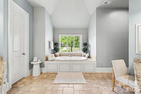 Jacuzzi tub in the primary suite with seperate shower