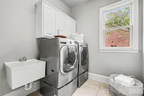 Main level Laundry room with sink and cabinets