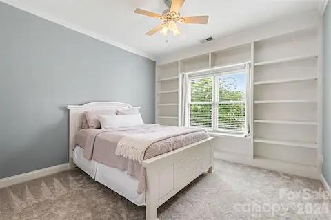 secondary bedroom with built in shelving