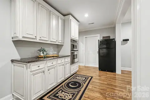 Lower level Kitchen space with countertop, microwave and oven
