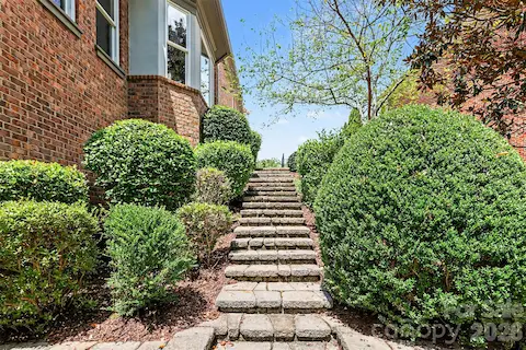 The Stone Columns and stone steps lead you down to the beautifully landscaped backyard