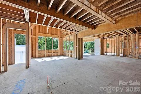 View from kitchen into dining area, great room, and back porch.