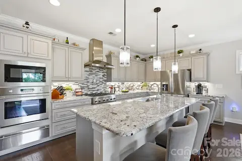 The open kitchen was made for gathering, centered around an oversized island with generous bar seating.
