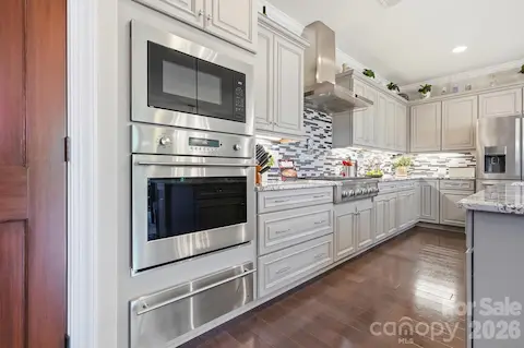 Beautifully equipped kitchen featuring Monogram appliances, wall oven, microwave, warming drawer and abundant cabinetry.