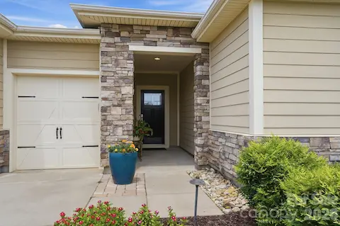 A covered entry accented with stone creates a warm welcome for you and your guests.