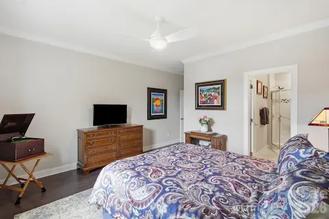 Another view of the secondary bedroom highlights its generous proportions and private bath access.