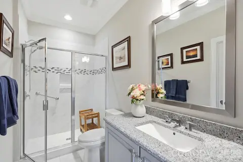 Beautifully finished en suite bath gives overnight guests a comfortable retreat of their own.