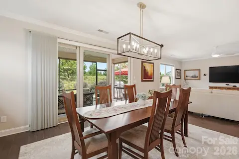 Dining opens directly toward the screened porch, making indoor-outdoor entertaining feel effortless.