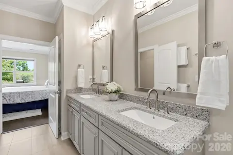 Dual vanities provide plenty of personal space while keeping the primary bath bright and polished.
