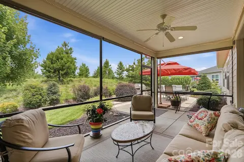 Surrounded by greenery, the screened porch offers a peaceful place to start or end the day.