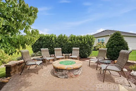 The firepit and lighted seating wall create an inviting destination for cool evenings and good conversation.