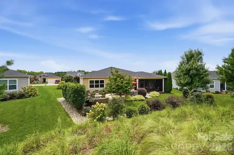 A rear view highlights the home's private setting and thoughtfully designed outdoor living spaces.
