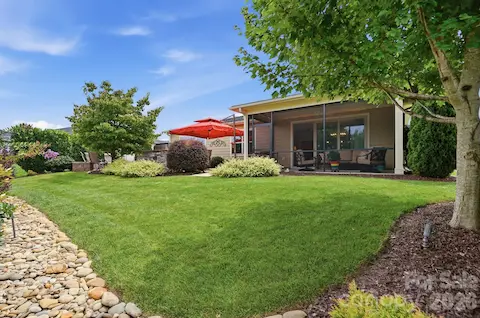 Beautiful lawn, mature landscaping and screened porch come together to create a backyard you'll actually use.