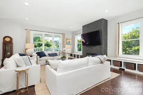 Expansive living room with fireplace, great natural light and built in window seating