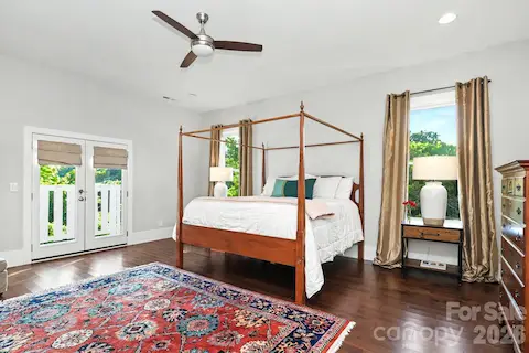 Primary bedroom with juliet balcony and view to uptown